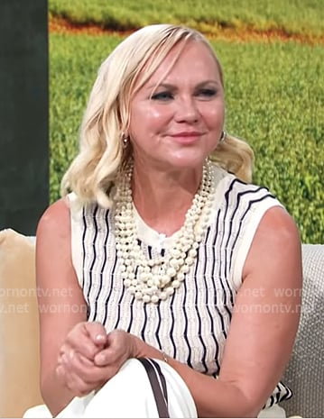 Galyna’s white striped knit vest and side striped pants on Access Hollywood