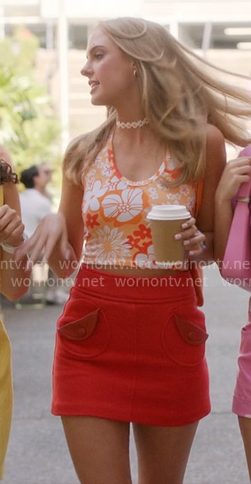 Madison’s tropical print top and red skirt on Elle