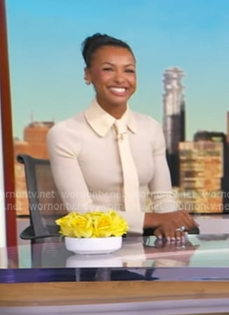 Malika Andrews’s ivory tie neck top on Good Morning America Malika Andrews’s ivory tie neck top on Good Morning America
