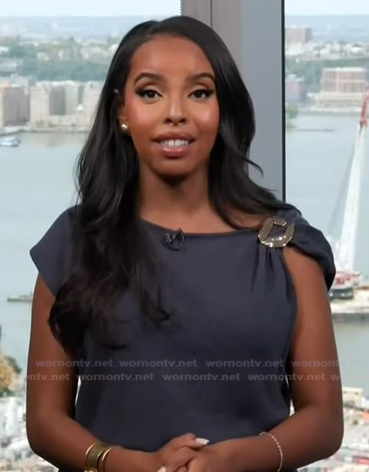 Mona’s black buckle shoulder top on Extra
