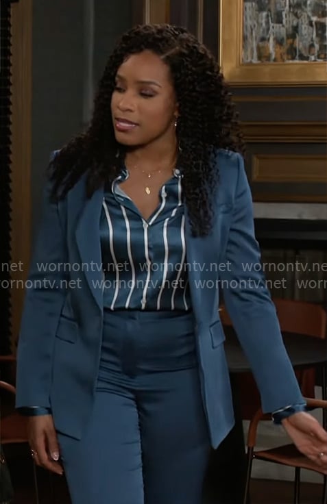 Naomi's teal blue suit and striped button down blouse on Beyond the Gates